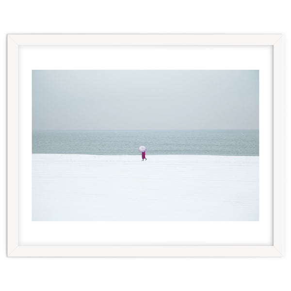 A walking woman in the winter snow beach