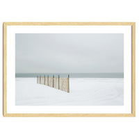 Wood fence in the winter snow beach