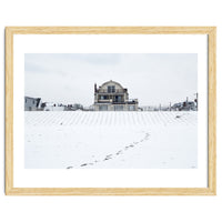 Footprints and house in winter snowscape