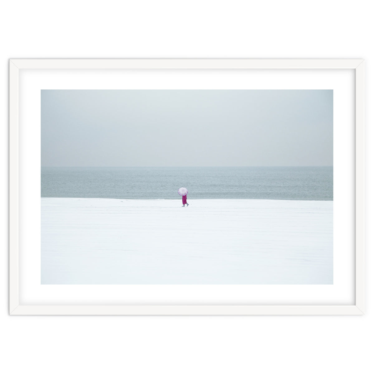 A walking woman in the winter snow beach