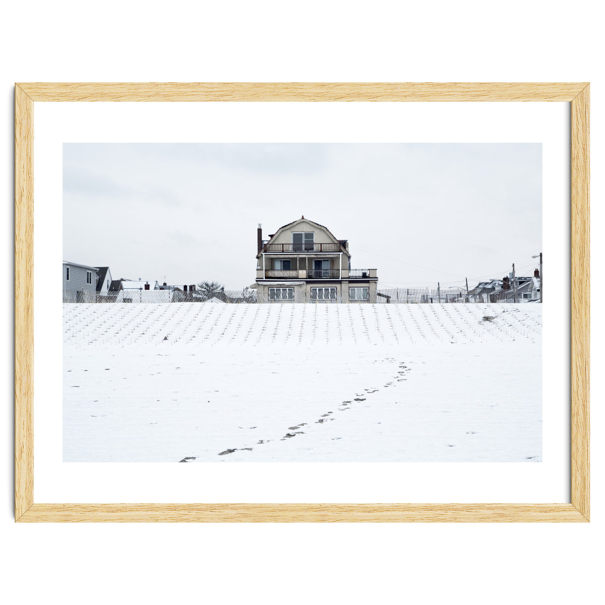 Footprints and house in winter snowscape