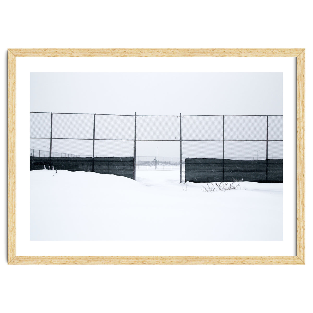 The entrance gate of the snow-covered baseball field