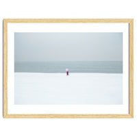 A walking woman in the winter snow beach