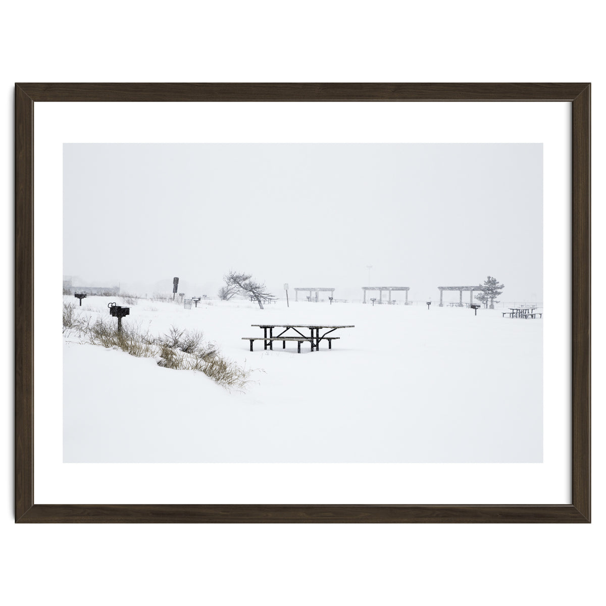 Tables and benches in a snow-covered park