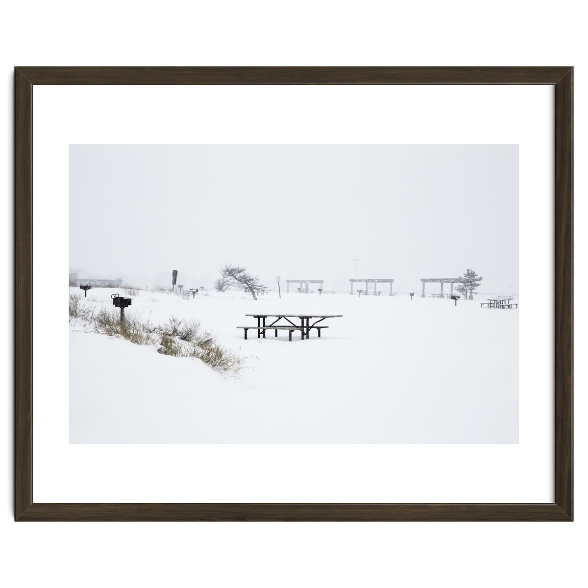 Tables and benches in a snow-covered park