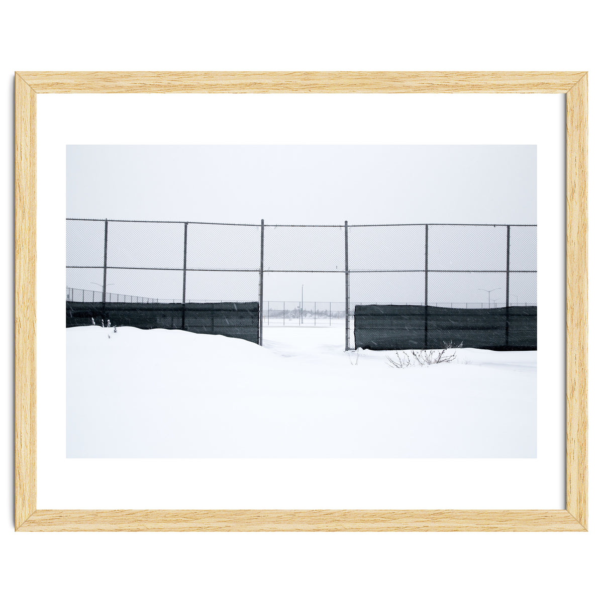 The entrance gate of the snow-covered baseball field