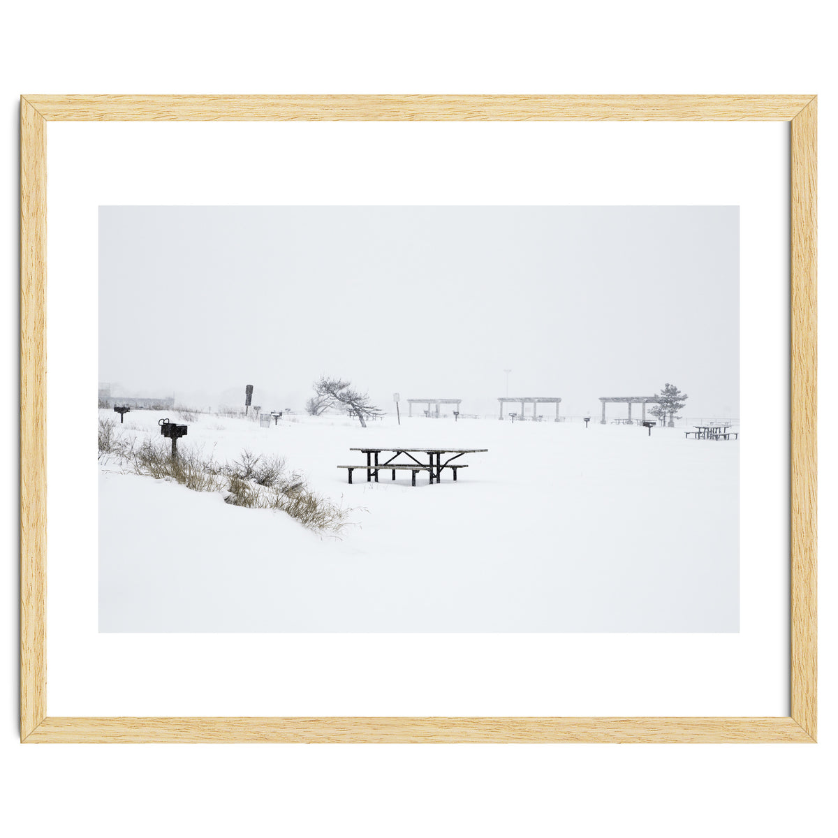 Tables and benches in a snow-covered park