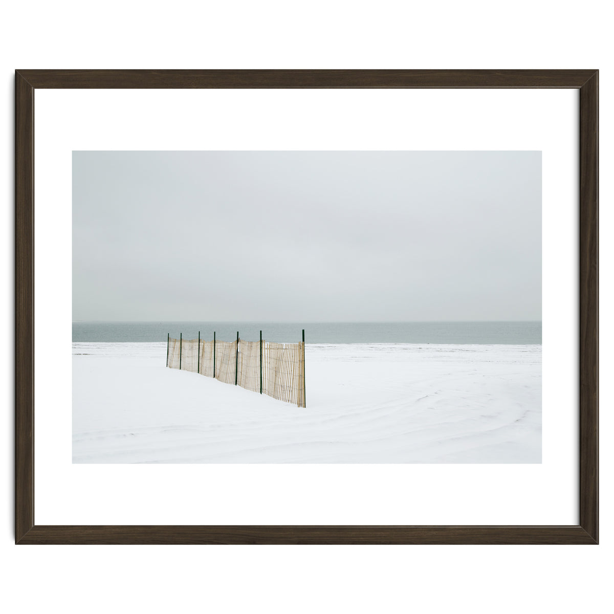 Wood fence in the winter snow beach