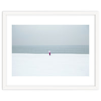 A walking woman in the winter snow beach