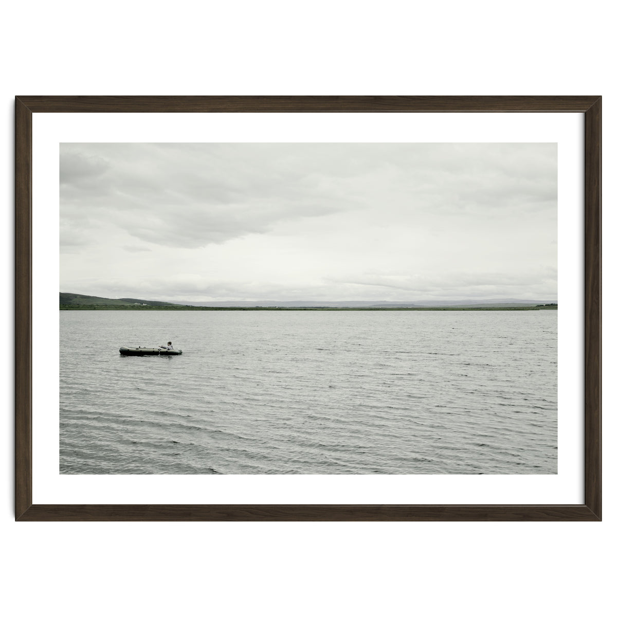 A boy pedaling the Board on the Lake - Iceland