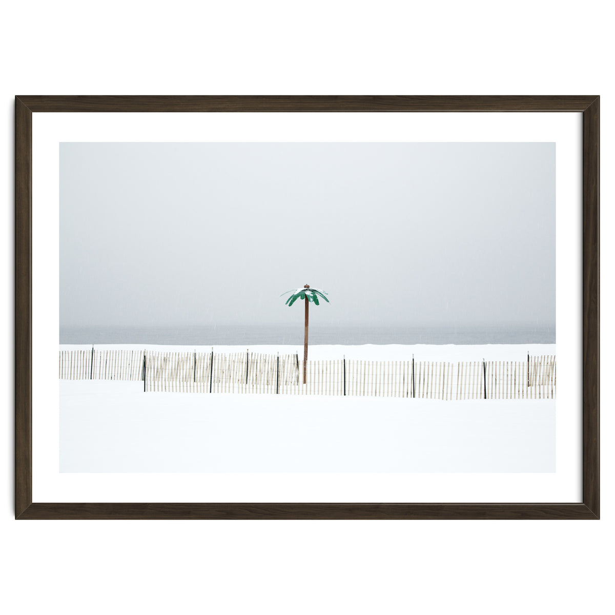 Fake palm tree in the winter snow beach