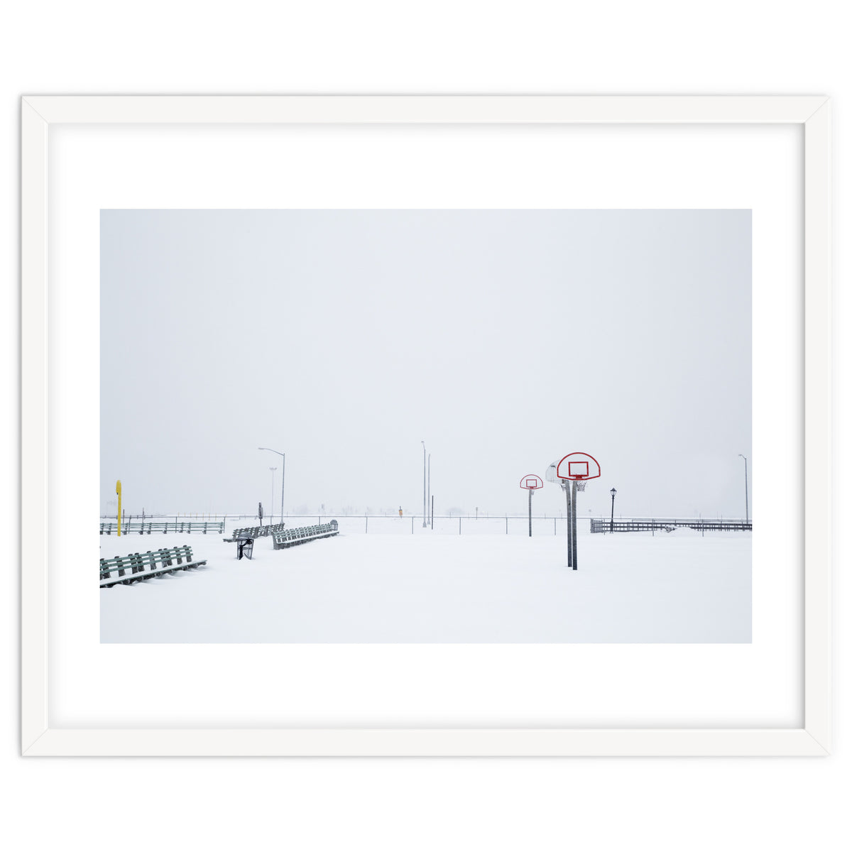 Snow-covered Basketball court and side bench