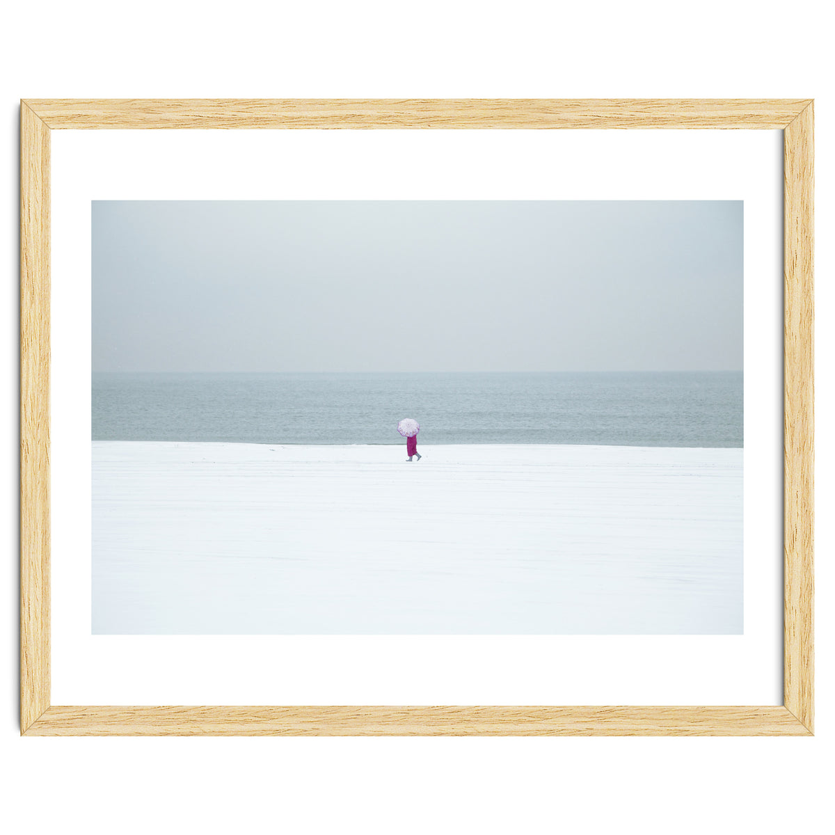 A walking woman in the winter snow beach