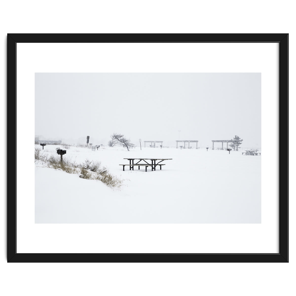 Tables and benches in a snow-covered park