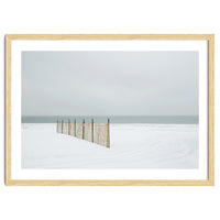 Wood fence in the winter snow beach