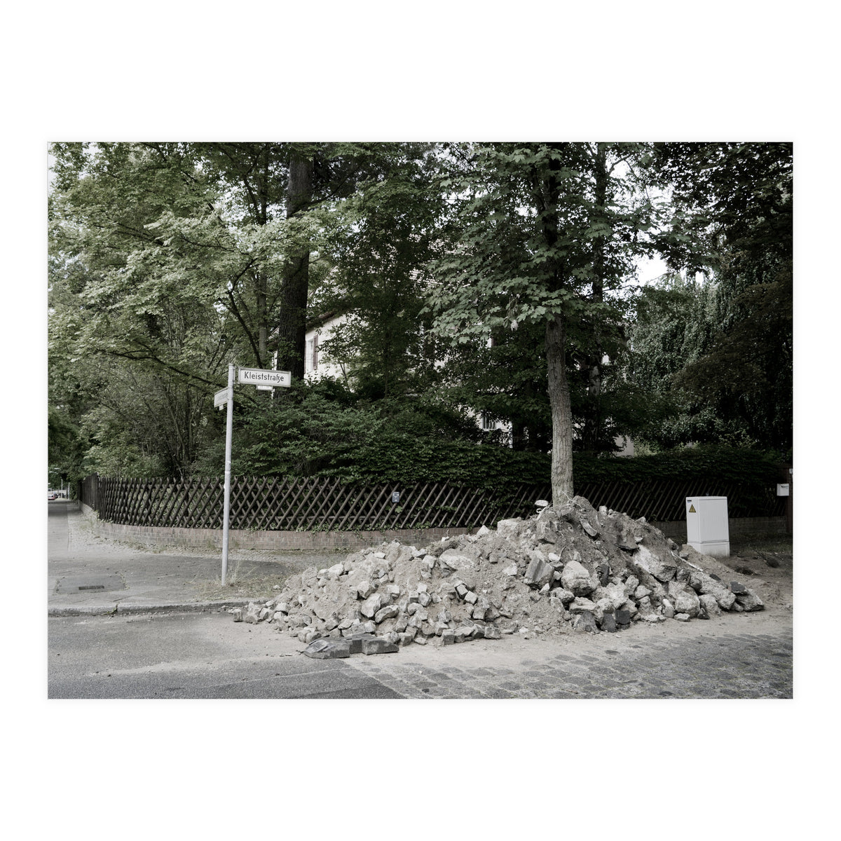 Piled-up rocks under construction on the street (Print Only)