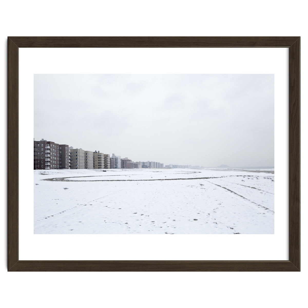 Traces of driving a car on a snowy coast