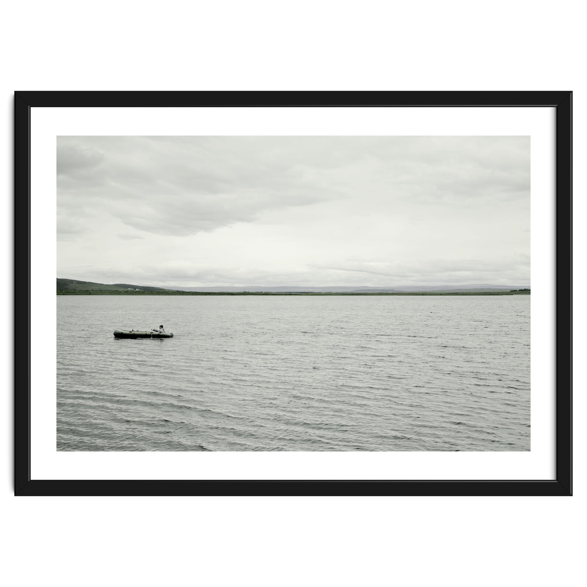A boy pedaling the Board on the Lake - Iceland