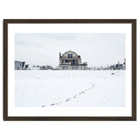 Footprints and house in winter snowscape