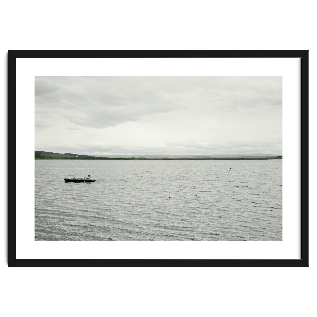 A boy pedaling the Board on the Lake - Iceland