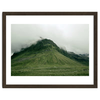 Green mountain covered in clouds - Iceland