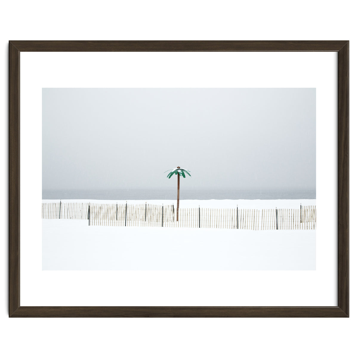 Fake palm tree in the winter snow beach