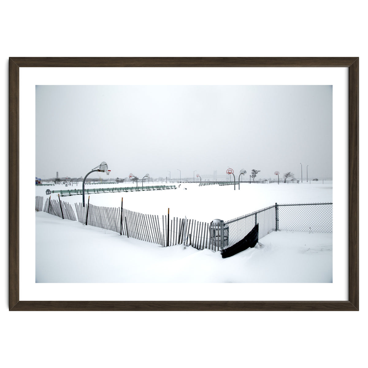 Snow-covered deserted basketball court in winter