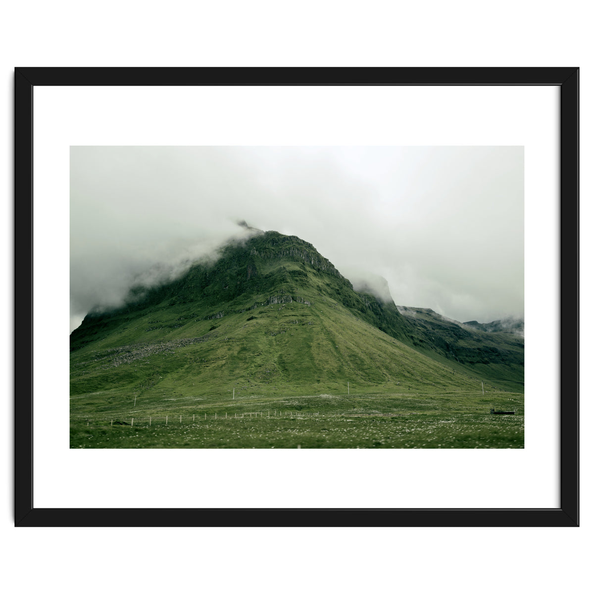 Green mountain covered in clouds - Iceland