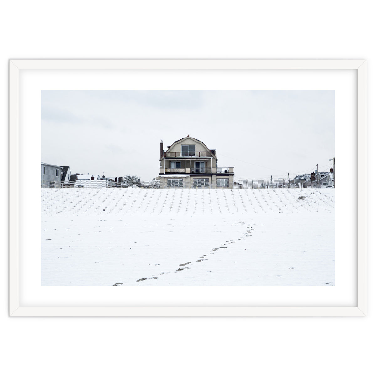 Footprints and house in winter snowscape