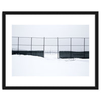 The entrance gate of the snow-covered baseball field