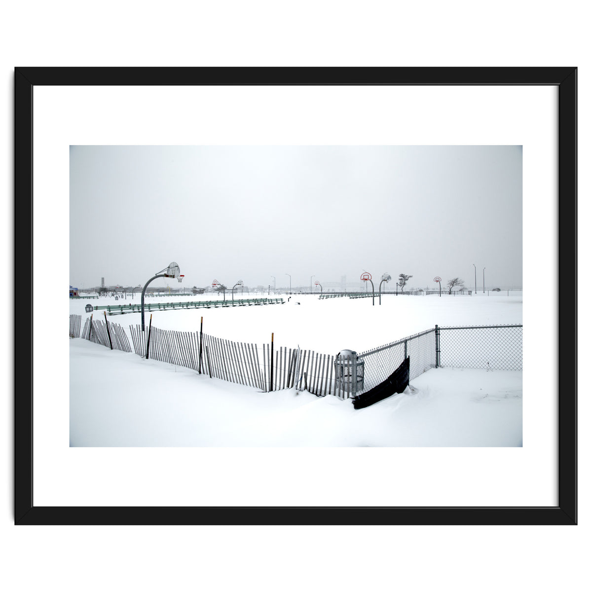 Snow-covered deserted basketball court in winter