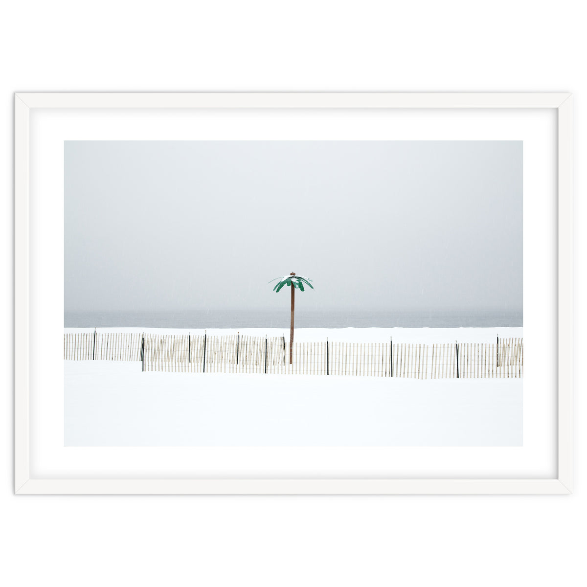 Fake palm tree in the winter snow beach