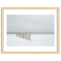 Wood fence in the winter snow beach