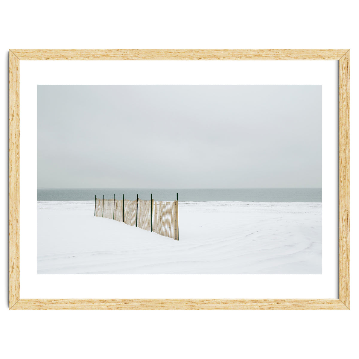 Wood fence in the winter snow beach
