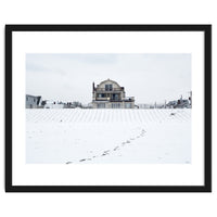 Footprints and house in winter snowscape