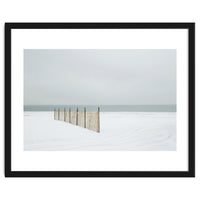 Wood fence in the winter snow beach