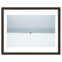 A walking woman in the winter snow beach