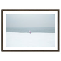 A walking woman in the winter snow beach