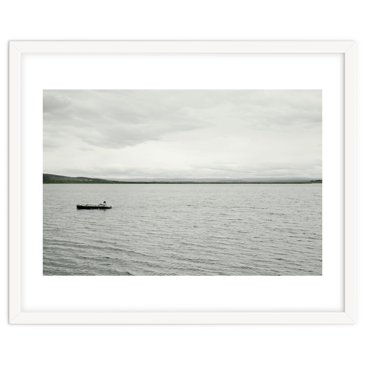 A boy pedaling the Board on the Lake - Iceland