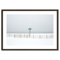 Fake palm tree in the winter snow beach