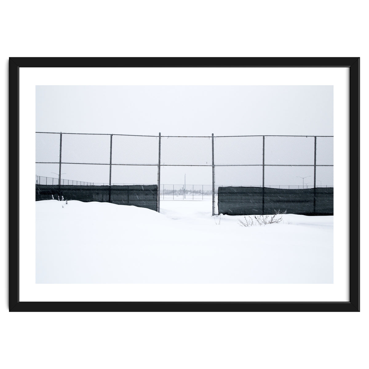 The entrance gate of the snow-covered baseball field