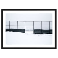 The entrance gate of the snow-covered baseball field