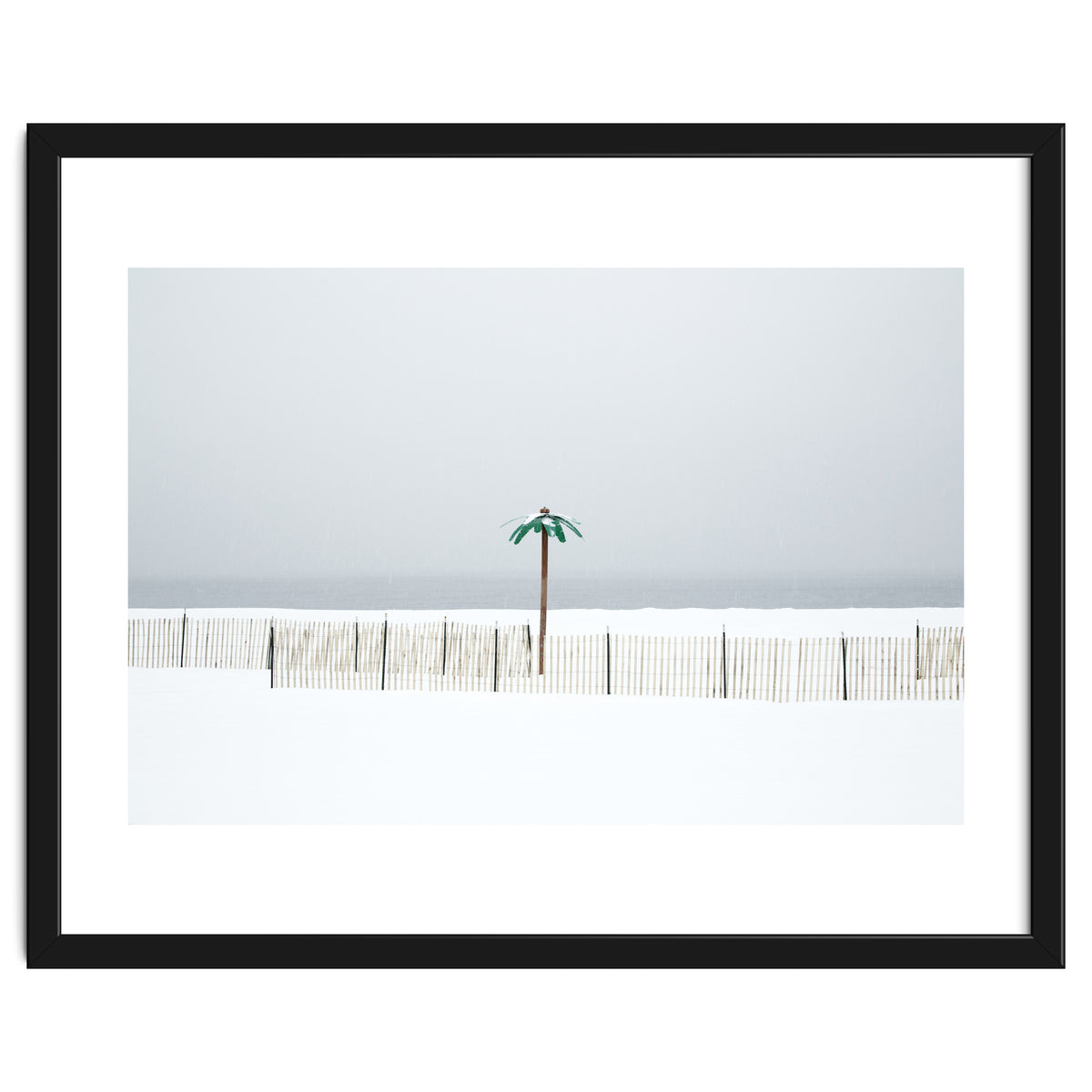 Fake palm tree in the winter snow beach