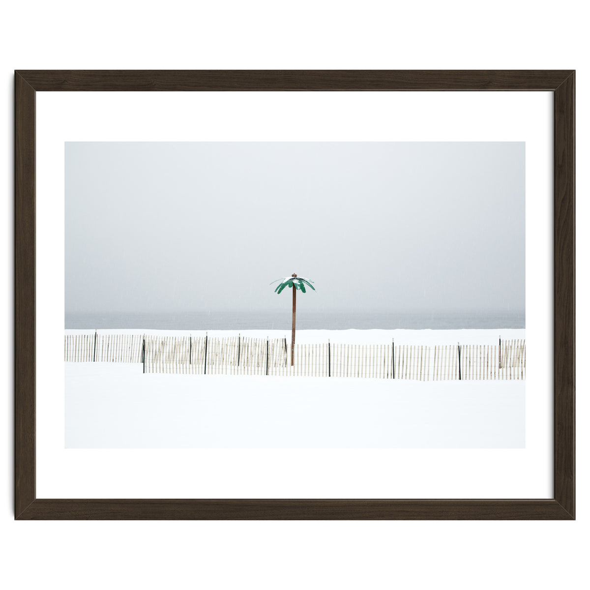 Fake palm tree in the winter snow beach