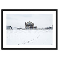 Footprints and house in winter snowscape