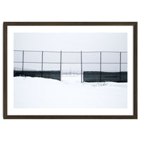 The entrance gate of the snow-covered baseball field