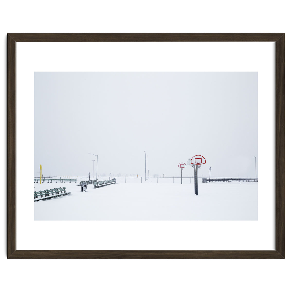Snow-covered Basketball court and side bench