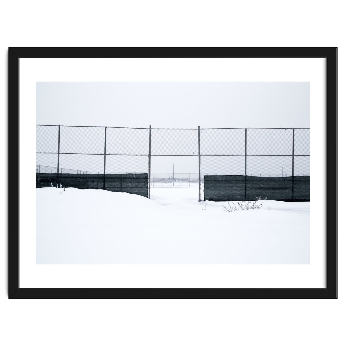 The entrance gate of the snow-covered baseball field
