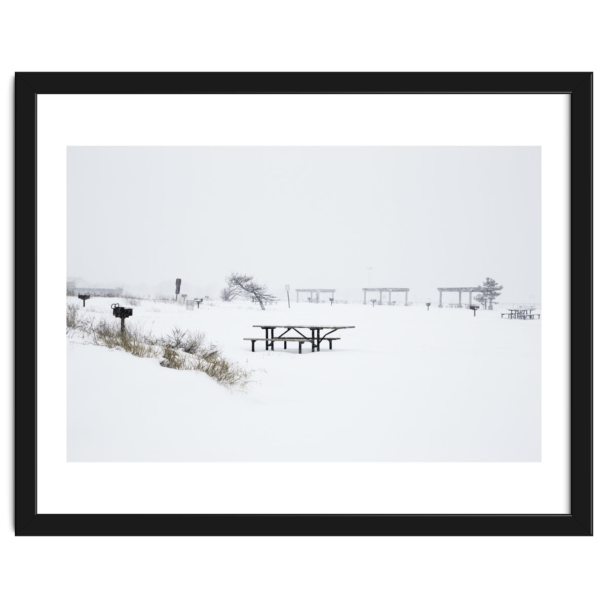 Tables and benches in a snow-covered park