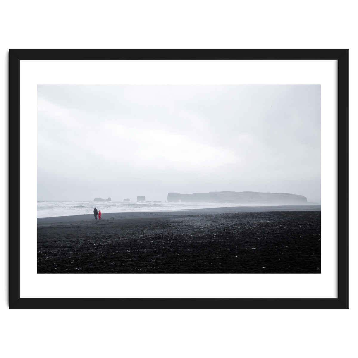 Family walking on the black sand beach - Iceland